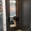 Patina metal panel pocket door with large mirror