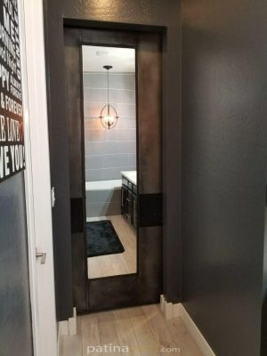 Dean-metal-mirror-side Patina metal panel pocket door with large mirror