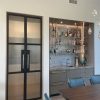 hinged double doors made with blacken steel and fluted glass