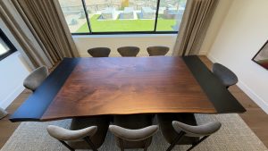 Overhead view of solid walnut live edge tabletop with blackened metal inlays in Scottsdale, Arizona