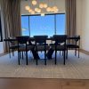 Angled blackened metal base under a live edge walnut dining table in Scottsdale, Arizona