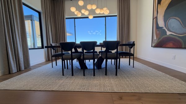 Angled blackened metal base under a live edge walnut dining table in Scottsdale, Arizona