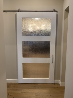 3 Panel Rain and Wood Door White painted wood barn door with three rain glass panels