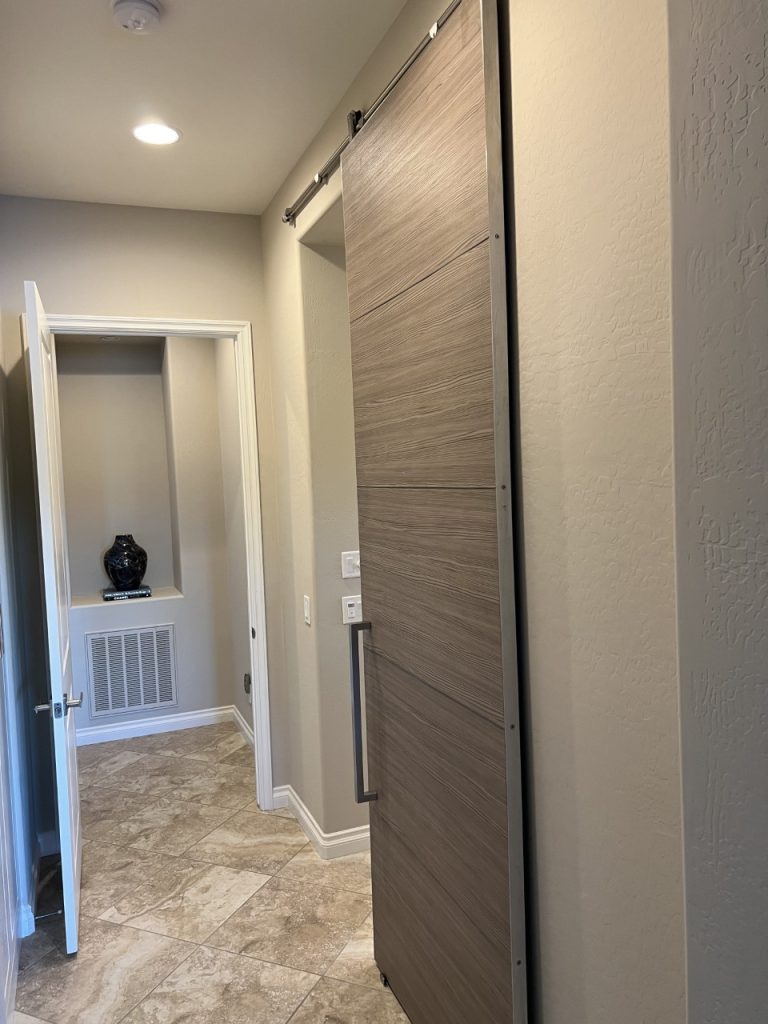 Gray wood grain 5 panel laminated barn door with brushed stainless trim