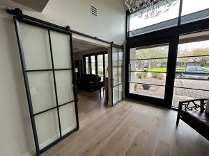 6 Grid Metal and Glass Barn Doors Black metal and frosted glass six grid barn door on an exposed track