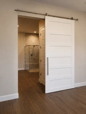 6 Panel Painted Shaker Barn Door White 6 panel painted shaker barn door opening to a bathroom