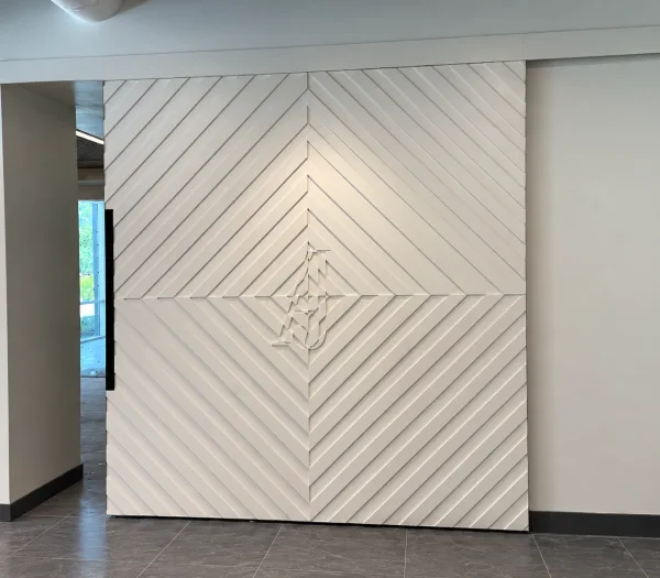 Large white painted chevron pattern barn door with initials in the center