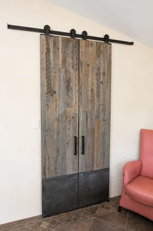 Double Reclaimed Wood Barn Doors with Metal Toe Kick Pair of reclaimed wood barn doors with metal toe kicks on a black track