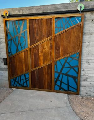 Exterior Metal and Wood Barn Door Exterior barn door with a metal frame, blue painted panels with metal overlay and wood center panels