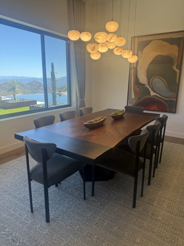 Live edge walnut dining table with blackened metal inlays and metal base in Scottsdale, Arizona