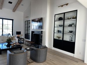 Metal and Glass Cabinet Doors Black metal and glass cabinet doors on built-in shelves beside a fireplace in a living room