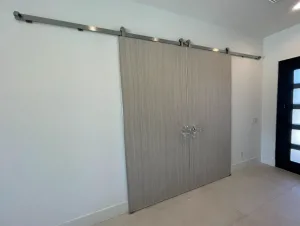 Set of Laminated Barn Doors Pair of gray wood grain laminated barn doors on a stainless steel track