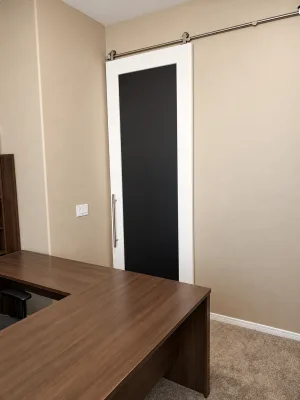 Shaker Style Painted Barn Door with Chalkboard White painted shaker barn door with a chalkboard panel beside a home office desk
