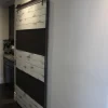 ranch style barn door with wire mesh and white weathered paint