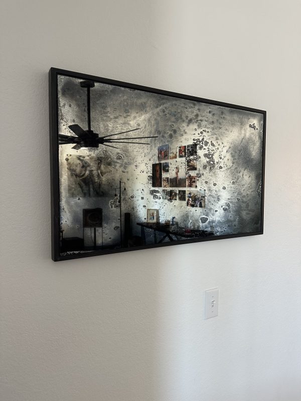 Artistic Antique Mirror Artistic antique mirror in a black frame on a white wall