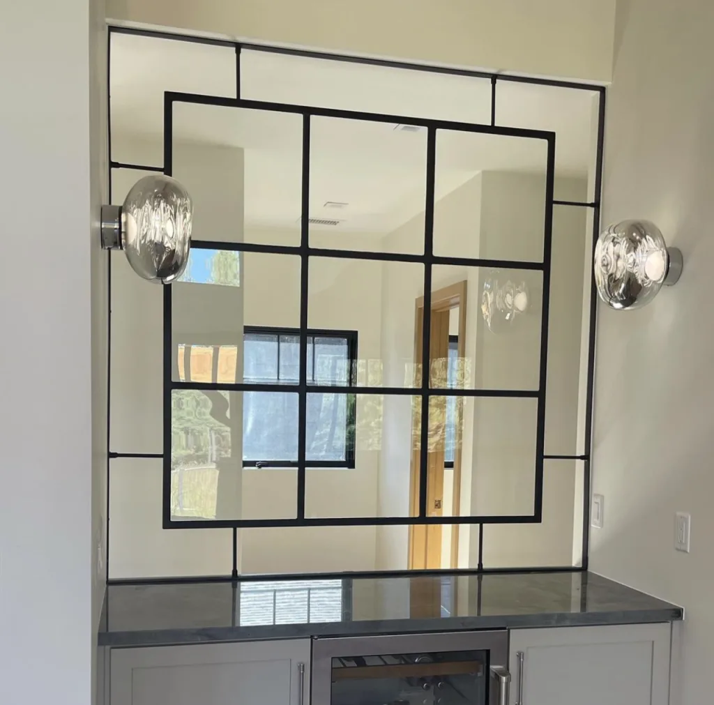 Floating black metal and glass interior window above a bar counter