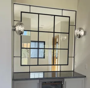 Floating black metal and glass interior window above a bar counter