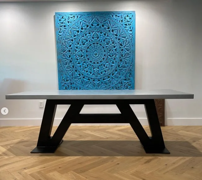 Black industrial metal A frame table base under a gray table top