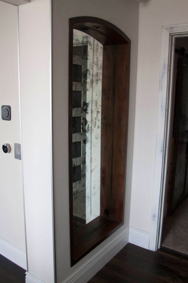 Large Inset Antique Mirror Built in arched antique mirror in metal frame.