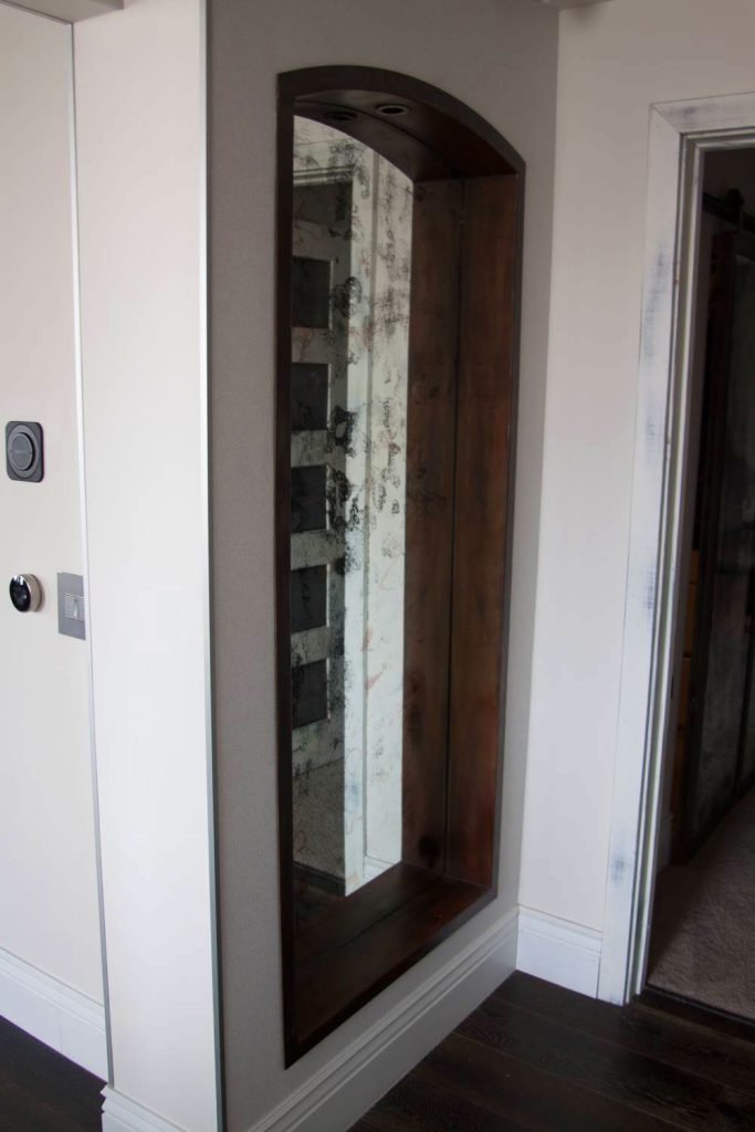Built in arched antique mirror in metal frame.