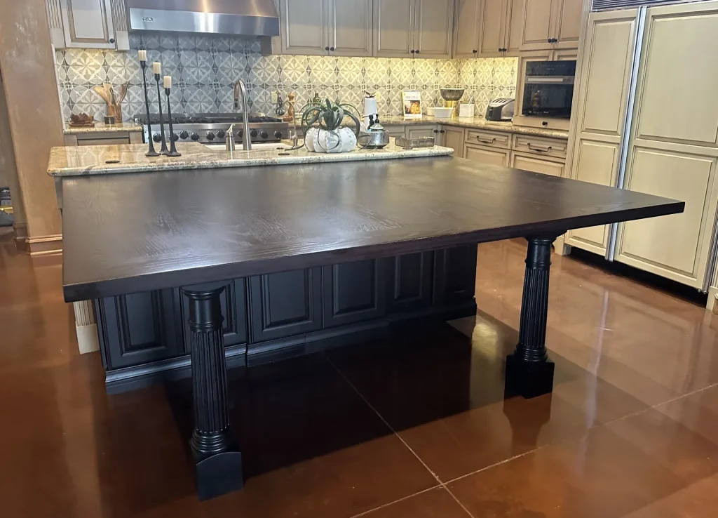 Large dark wood dining table extending from a kitchen island