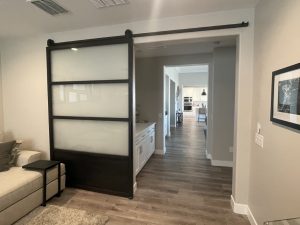Large Metal and Glass Barn Door Large black metal and frosted glass barn door with a solid lower panel