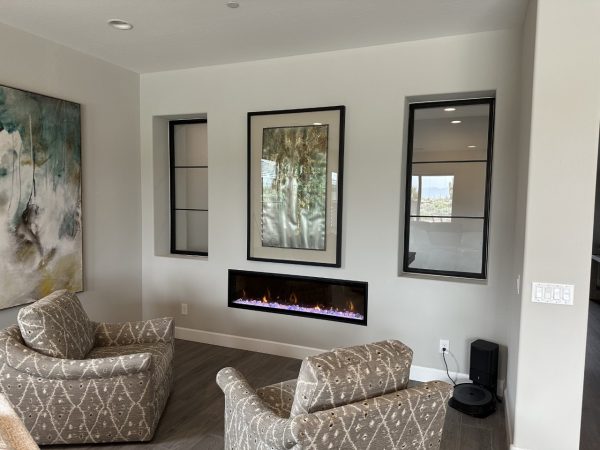 Metal and Glass Interior Windows Black metal and glass interior windows on either side of artwork above a fireplace