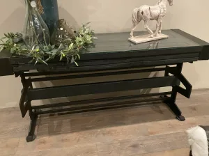 Metal and Glass Side Table Black metal console table with a glass covered door top and decor