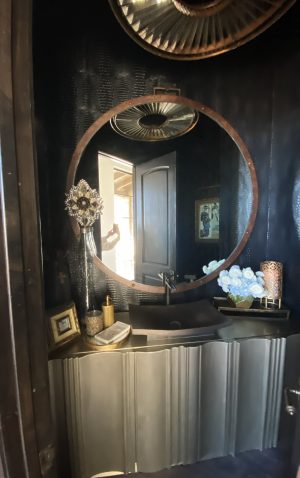 Round Industrial Mirror Round industrial mirror above a powder room vanity