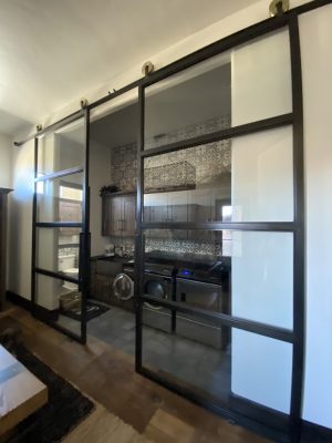 Set of Large Metal and Glass Sliding Doors Set of large black metal and glass sliding doors to a laundry room