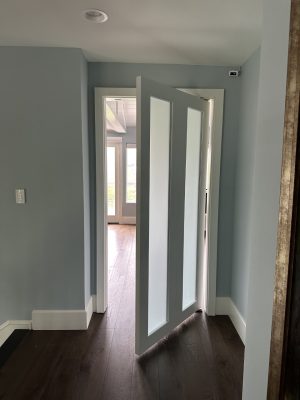 Painted Shaker Style Pivot Bedroom Door White painted shaker style pivot door with satin glass panels opening into a bedroom