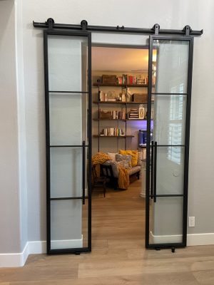 Small Office Metal and Glass Barn Doors Pair of black metal and frosted glass barn doors to a small home office