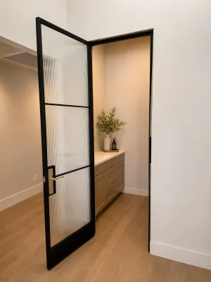 Open black steel and reeded glass hinged pantry door