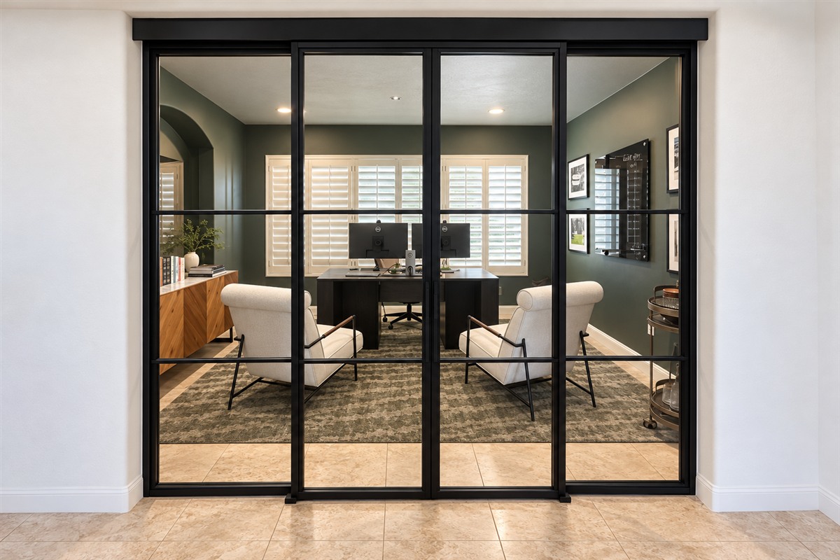 Top track sliding double metal and glass doors into a home office