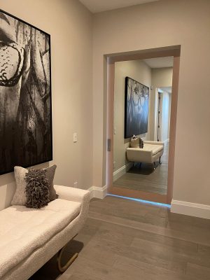 Wood Veneer Door with Mirror Wood veneer barn door with a mirror inset in a hallway