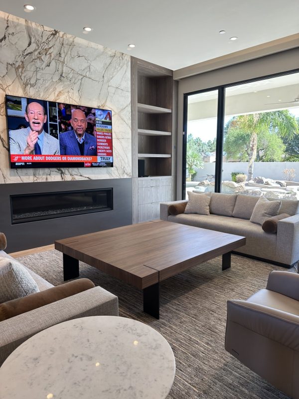 Large walnut coffee table with metal plate legs in a living room