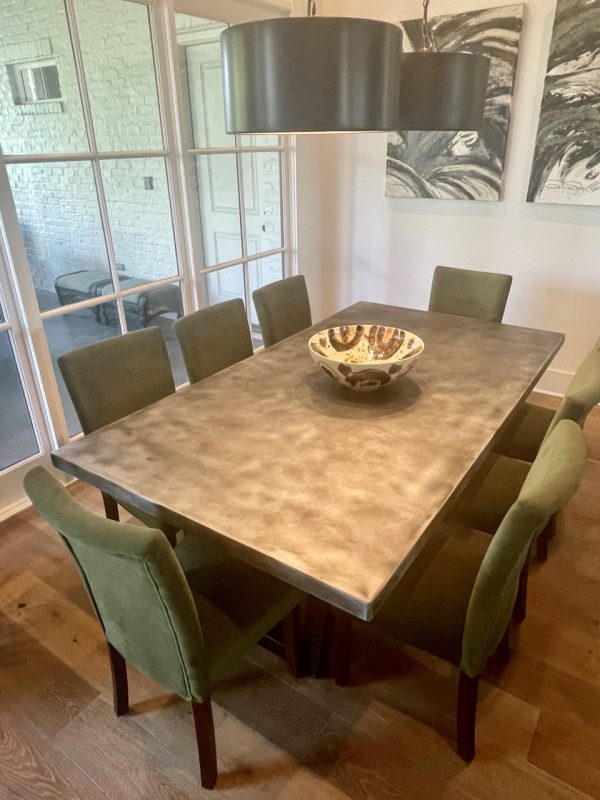 Zinc top dining table for eight with green upholstered chairs
