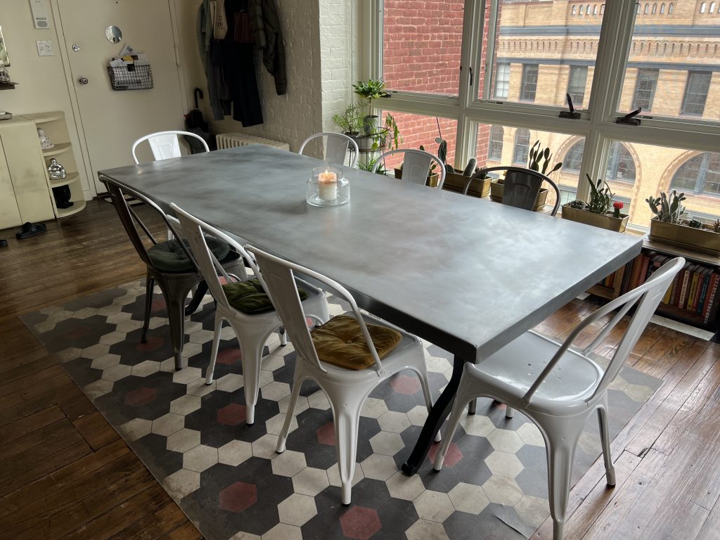 Zinc dining table top with metal wishbone legs and metal chairs