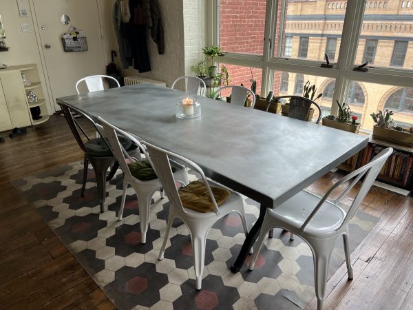Zinc dining table top with metal wishbone legs and metal chairs